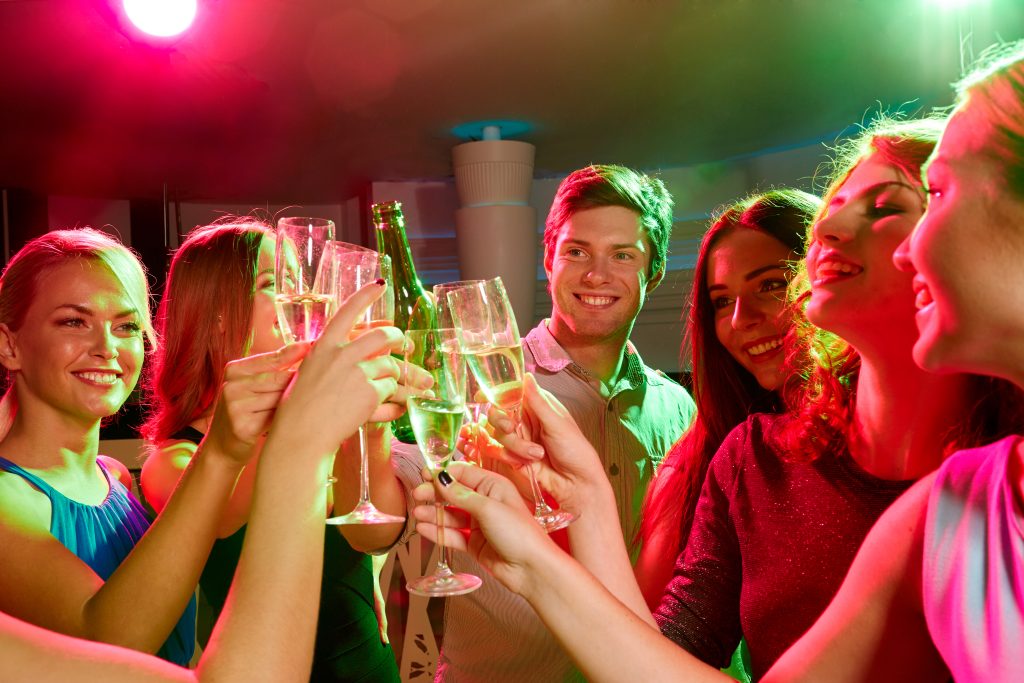 A group of people drinking and having fun at an evening party