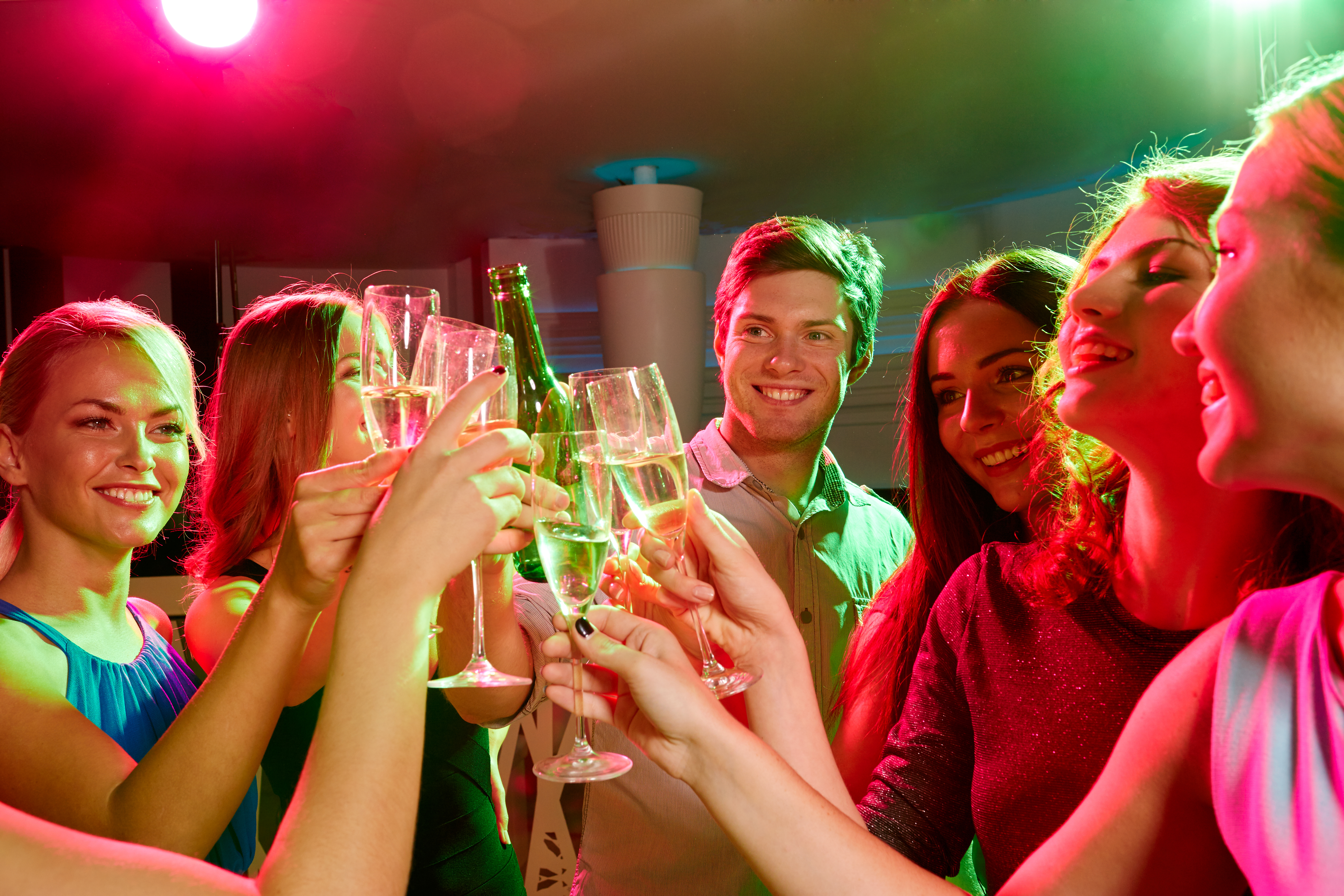A group of people drinking and having fun at an evening party